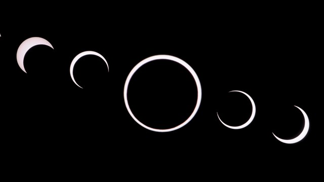 Phases of the moon from left to right against a black background.