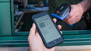 Entrance sign for Bryce Canyon National Park beneath the Milky Way
