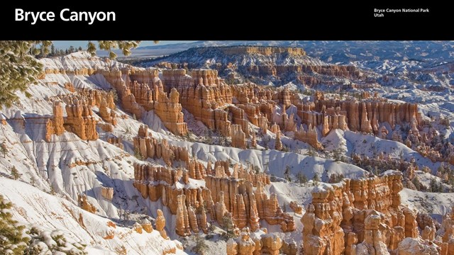 The cover of an NPS brochure showing red rock formations covered in snow.
