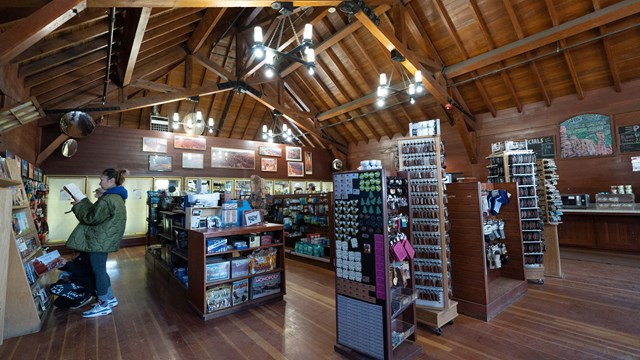 The interior of a rustic building with displays of souvenirs and gifts.