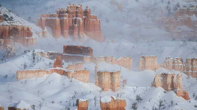 A snowy landscape of red and white limestone rocks