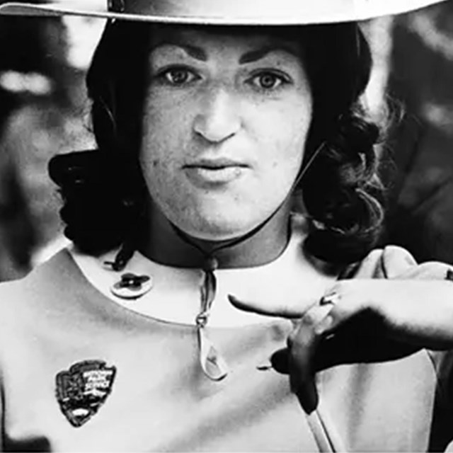 black and white photo of woman in a park ranger uniform