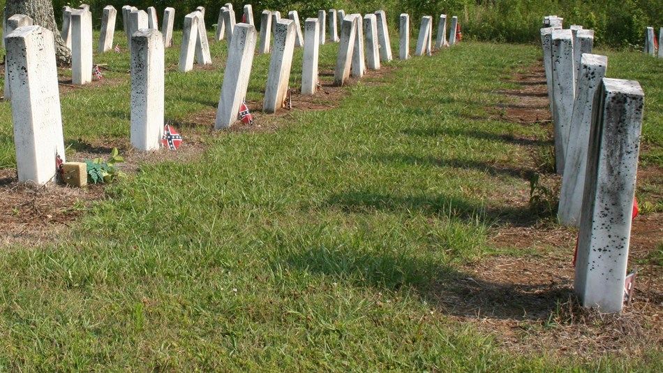 rows of white gravestones mark where confederate soldiers who died in the battle are buried