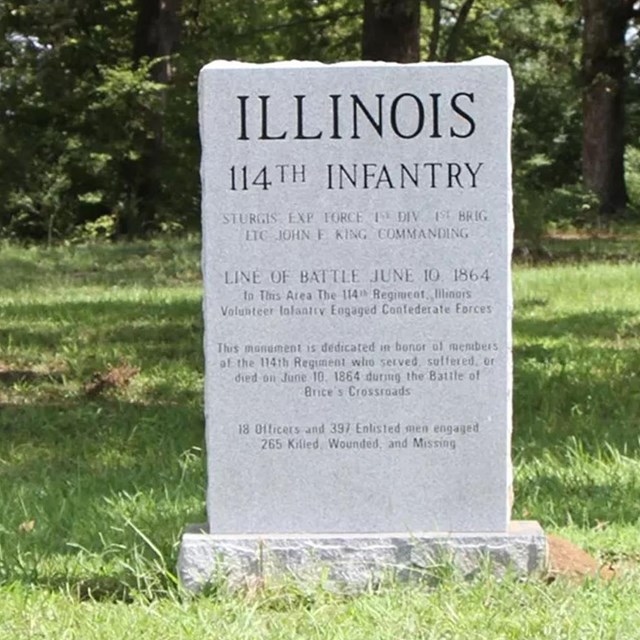 A stone monument commemorating the Illinois 114th Infantry