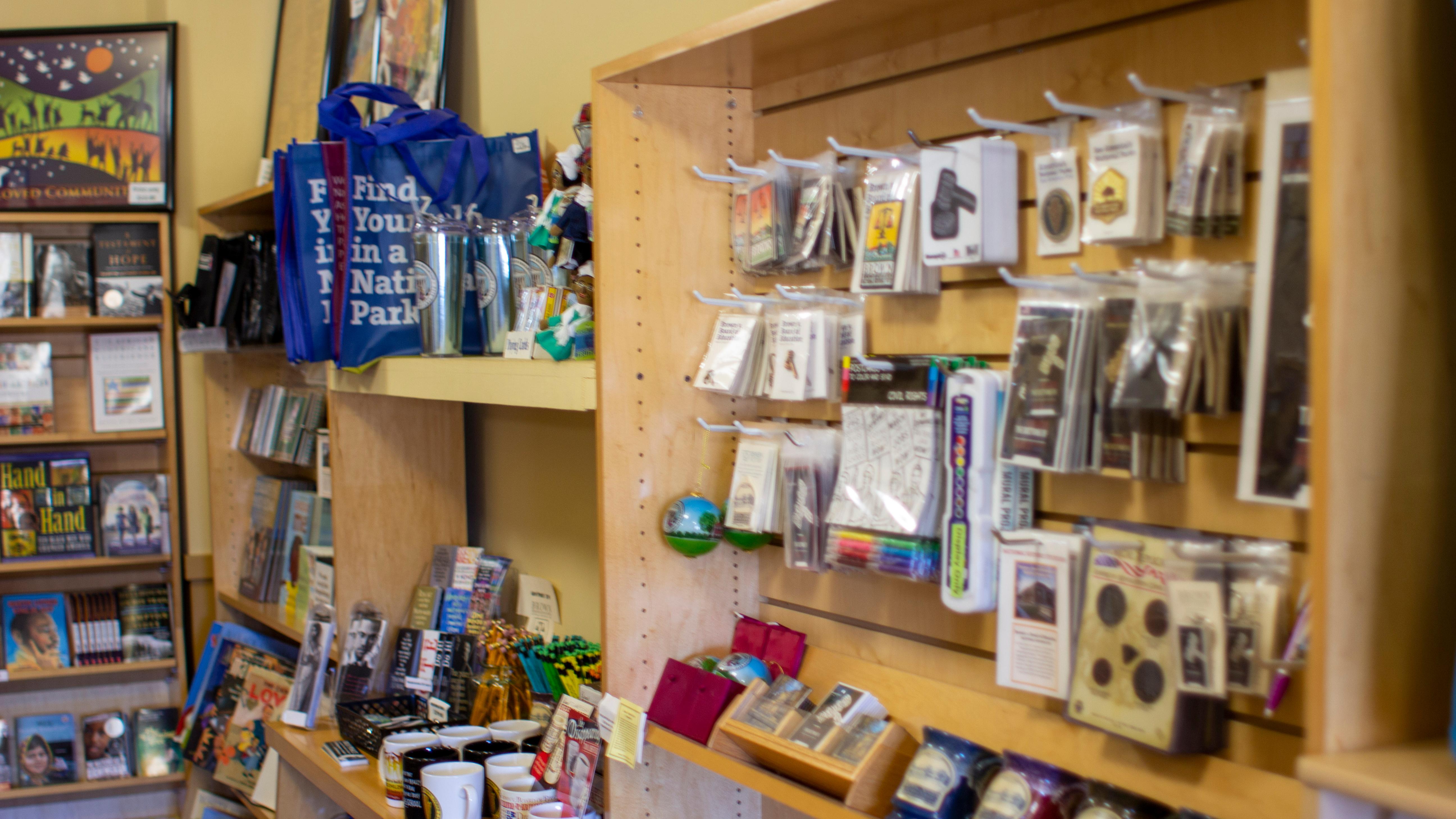 Books, Mugs, Postcards, Shirts, Bags, Patches, Coins, and much more are available for purchase.