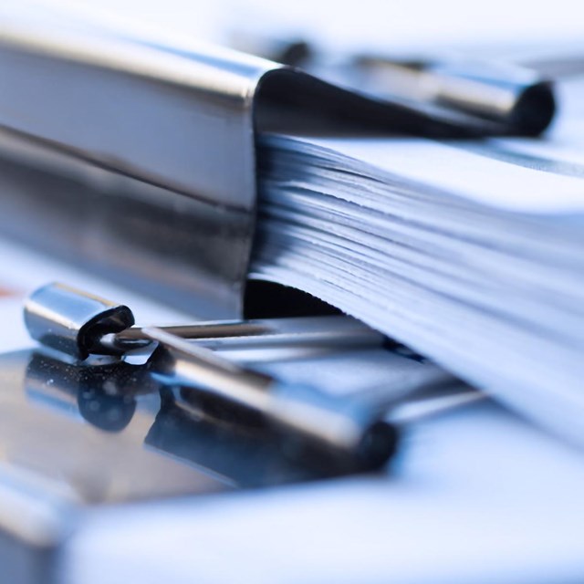 bundles of paper attached with binder clips