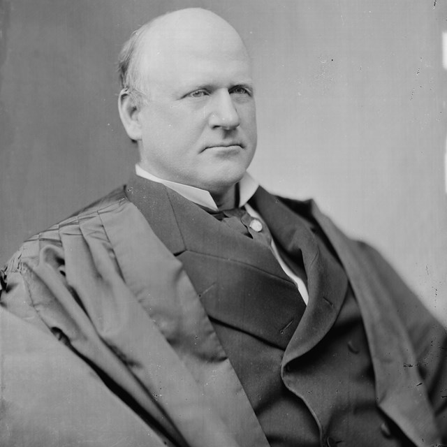 Justice John Marshal Harlan sits in his judicial robes