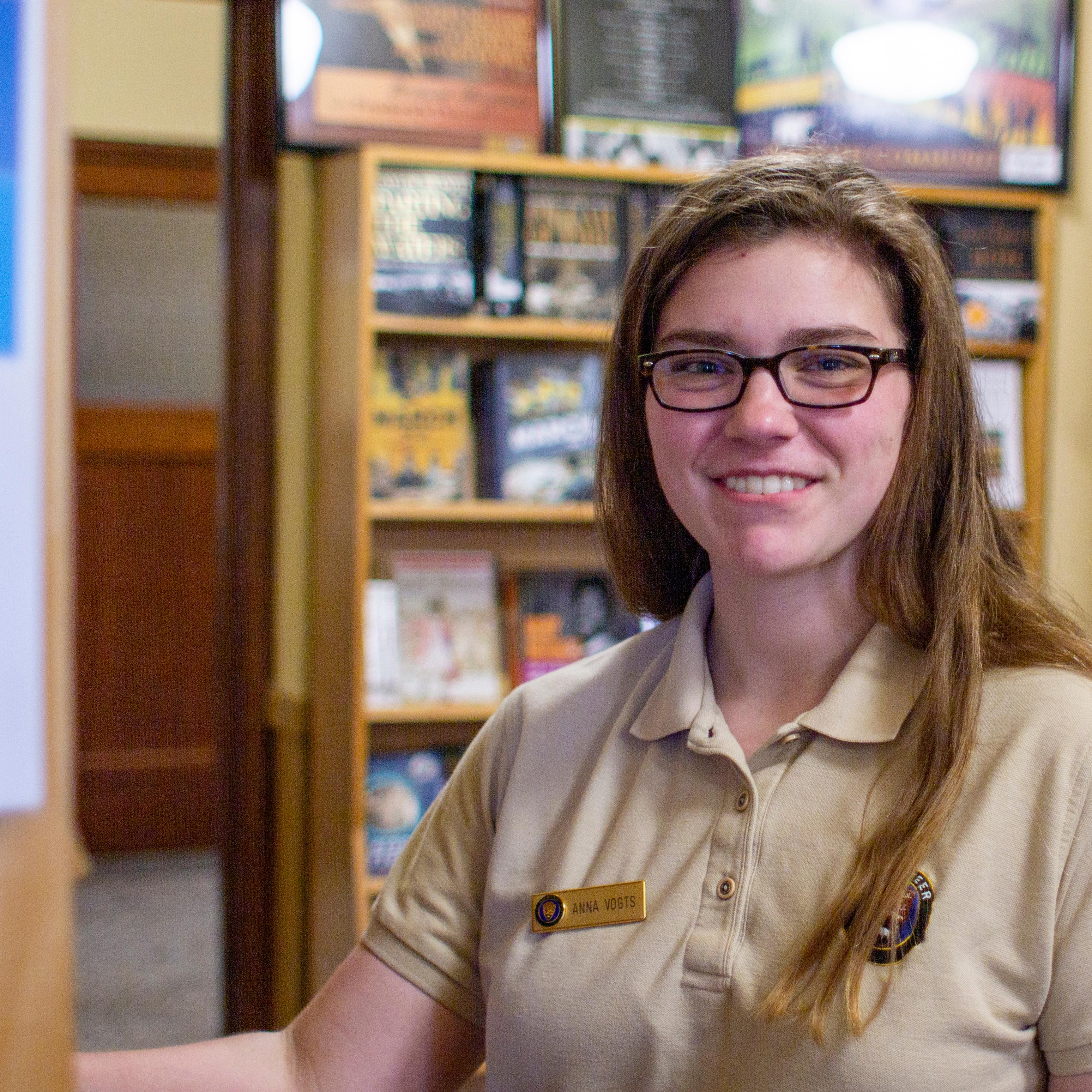 Volunteer restocks bookstore shelves