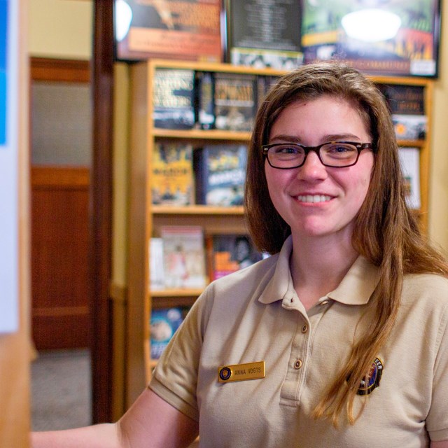 Volunteer restocks bookstore shelves