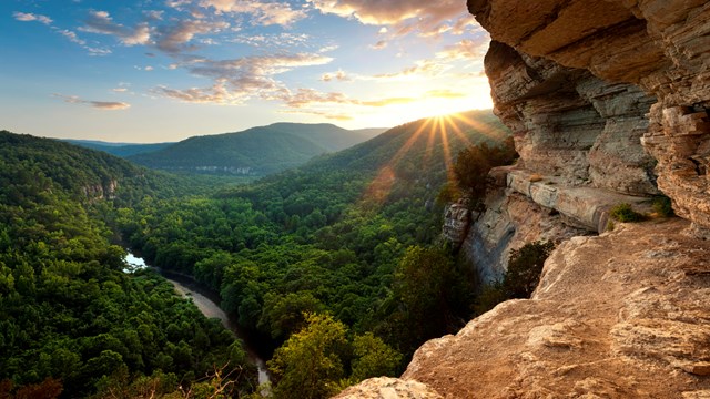 From a high, narrow ledge we view the rugged, wooded hills of the Ponca Wilderness.