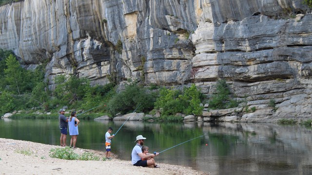 Adults and children fishing on the Buffalo River