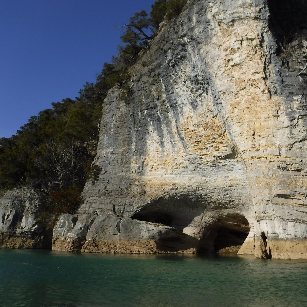 A vertical bluff along the river bank.