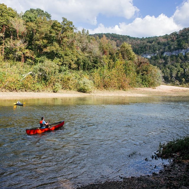 A canoeist paddles downriver at Spring Creek Access.