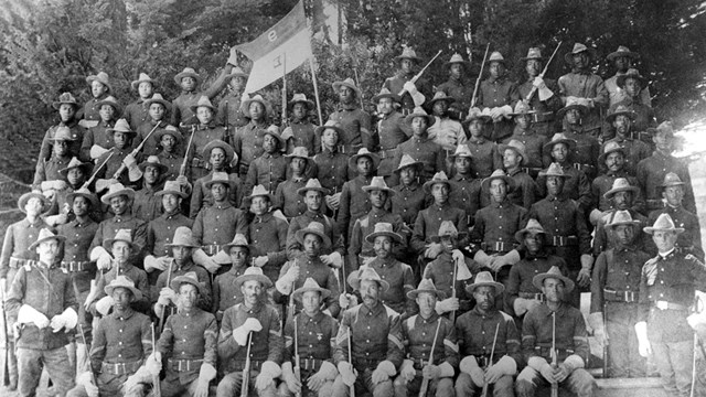 Several african american soldiers standing for a company photo