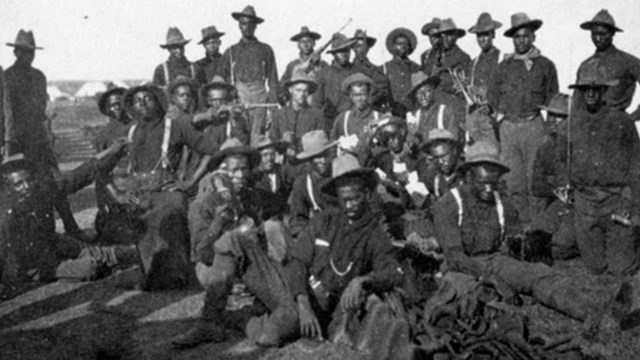 Several african american soldiers pose for a relaxed photo