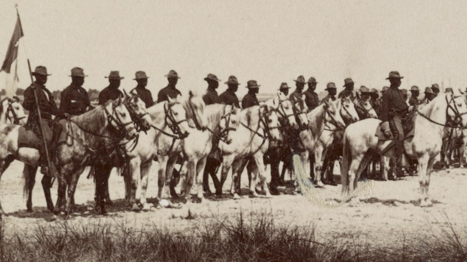 Several african american mounted soldiers in formation