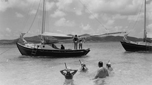 Historic photo of sailboats and snorkelers at Buck Island, ca. 1960s.