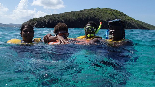 children snorkeling the clear waters at Buck Island