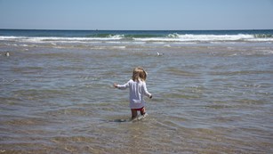 Girl playing in the water at the beach