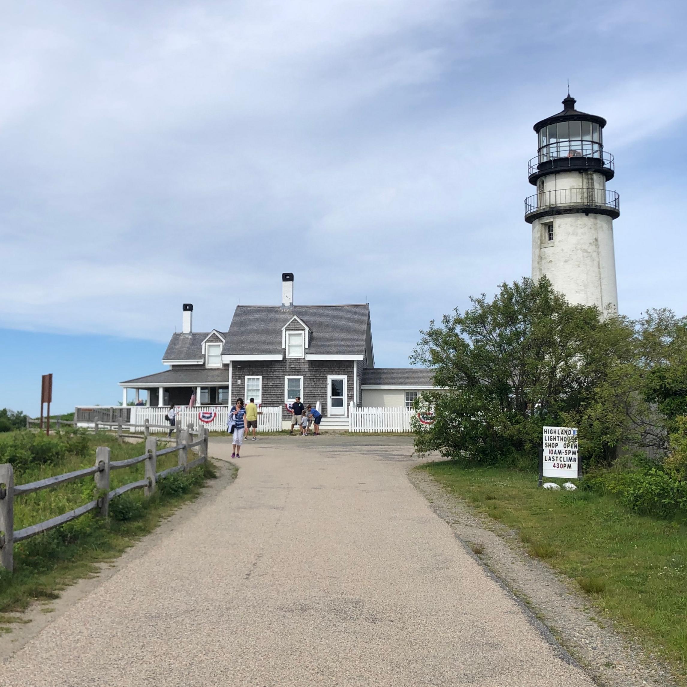 A driveway leads up to a house with a lighthouse next to it.