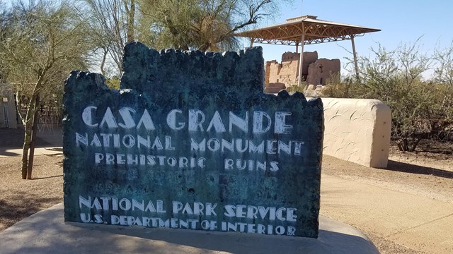 Casa Grande Ruins National Monument Historic Sign with Great House in Background