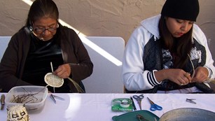 two American Indian basket weavers at work