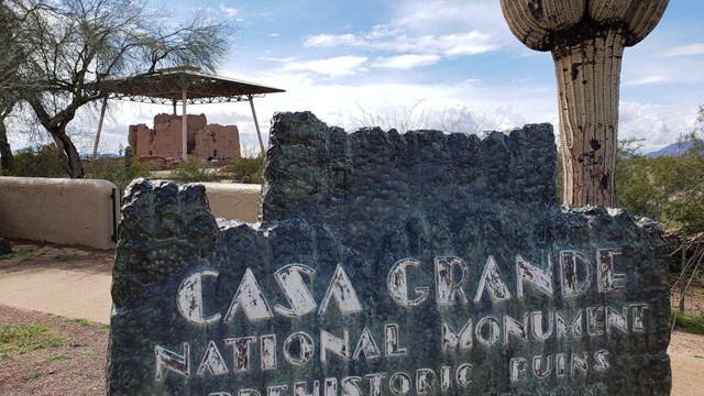 Casa Grande Ruins National Monument Historic Sign with Great House in Background