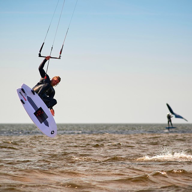 A kiteboarder sailing above the water