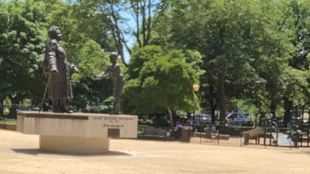 Statue of Mary McLeod Bethune in front of trees.