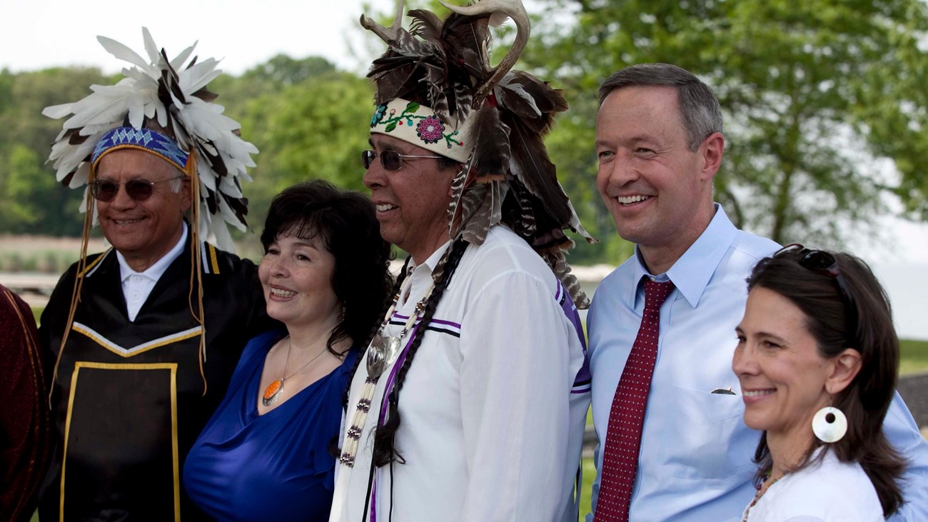 A group of people pose for a portrait at a formal event. 