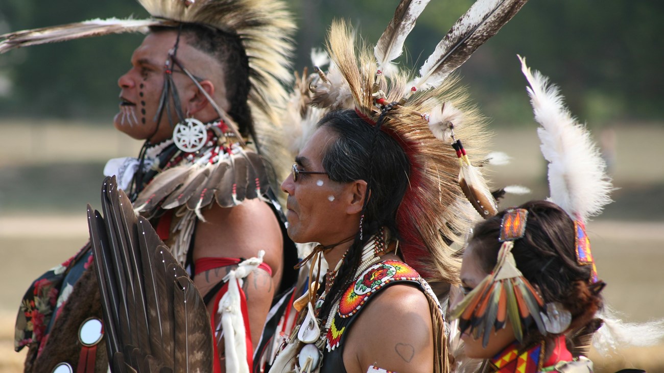 Three contemporary American Indian dancers in regalia.