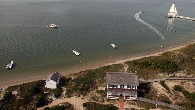 Aerial view of Lighthouse Keeper's house with boats in the water
