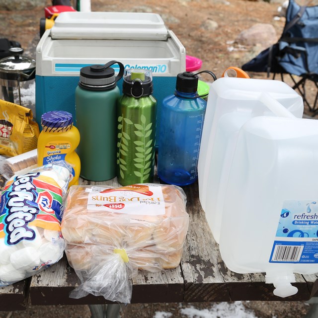 food and water on picnic table