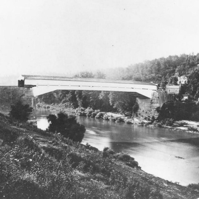 A covered bridge over a waterway at the time of the Civil War.