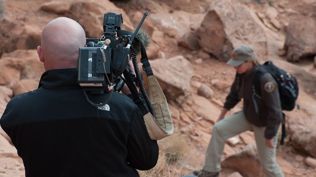 a videographer films a park volunteer