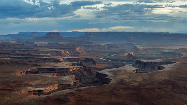 A sweeping view of a network on canyons and spires viewed from atop a highpoint. 