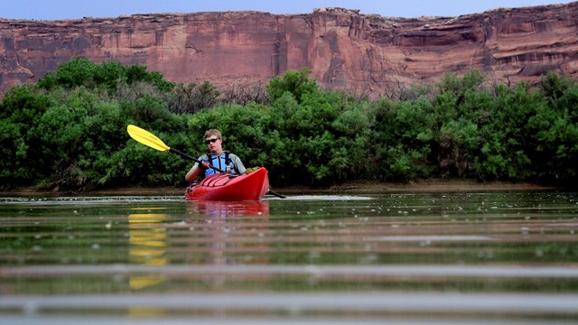 Person in a red kayak on a river