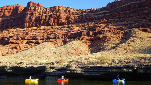 Colorful boats float along a river