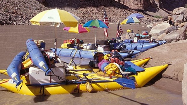 Colorful boats parked along a river's edge