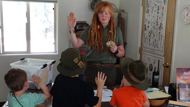 Volunteer saying Junior Ranger pledge with three children and an adult.