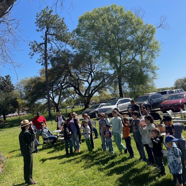 Ranger swearing in group of children as Jr. Rangers