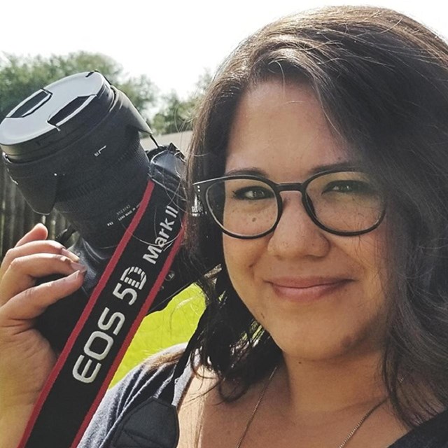 A woman holding a camera.