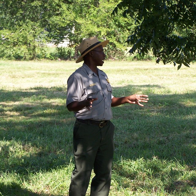 Ranger standing in grassy field