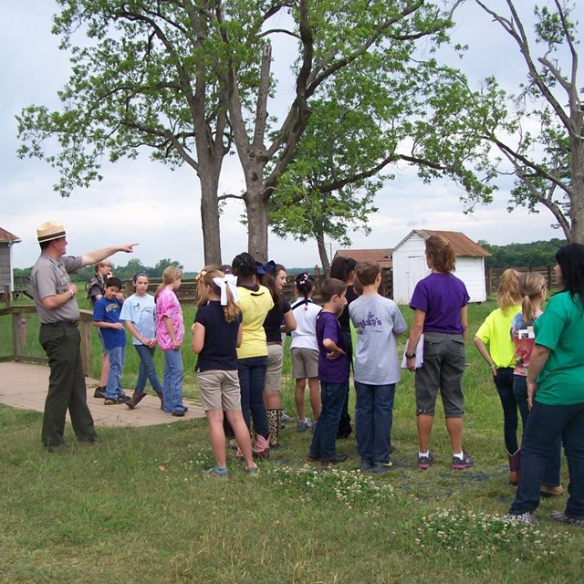 Ranger on bridge with group of visitors. 