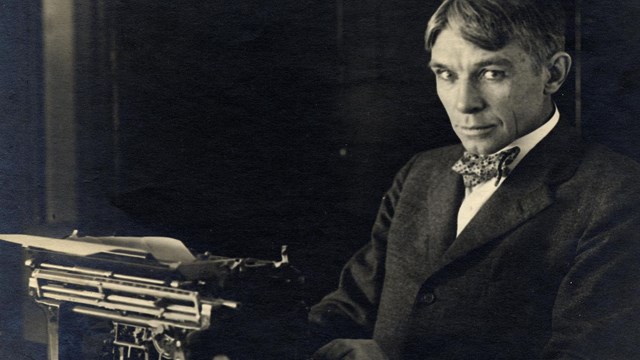 image of Carl Sandburg sitting at a typewriter