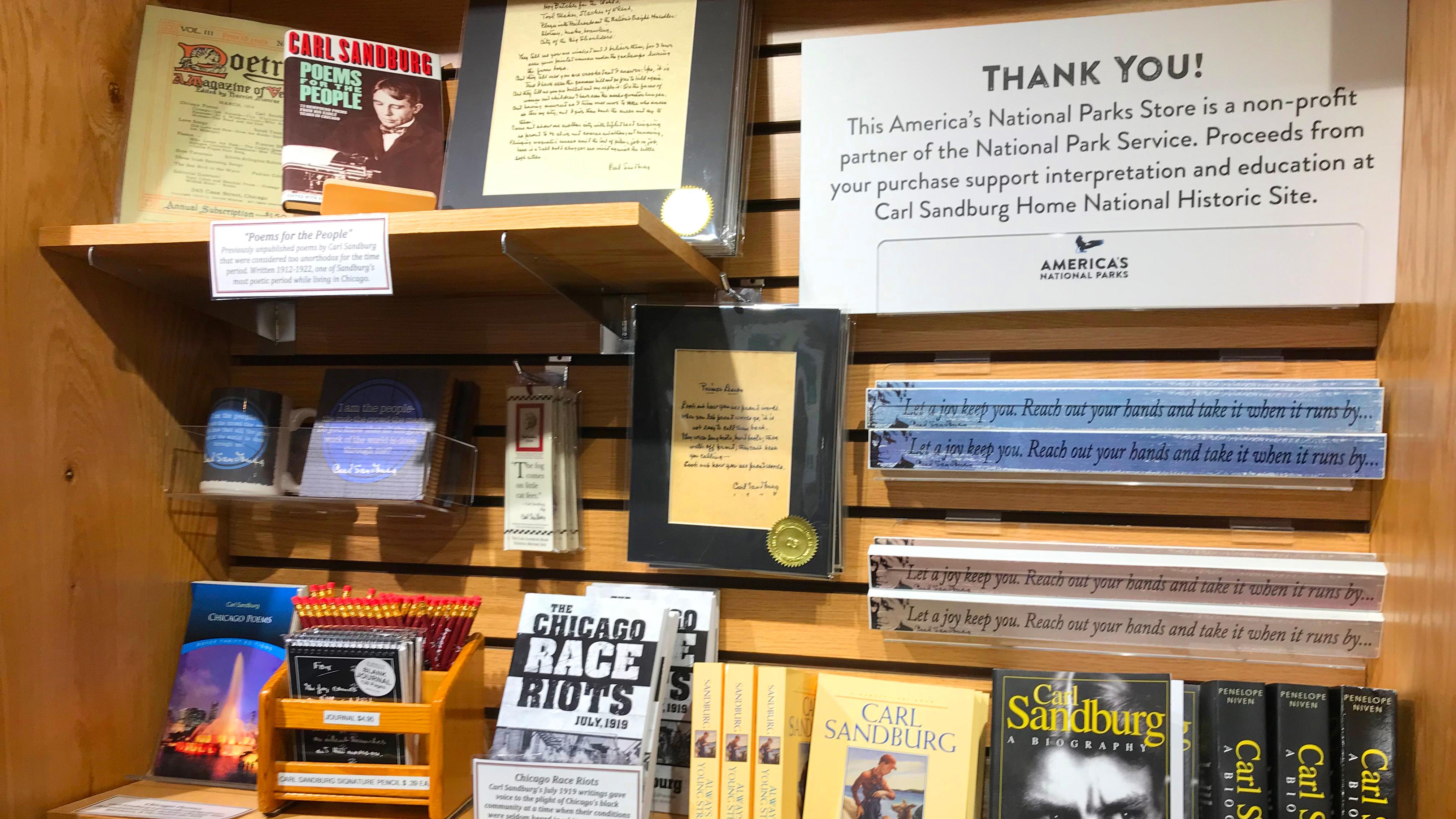 Bookshelf with store merchandise and a sign that says Thank You!