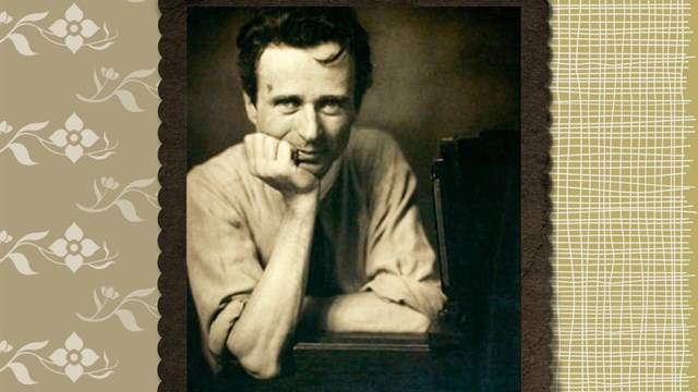 Sepia toned photo of man with his head in his hand sitting at a desk