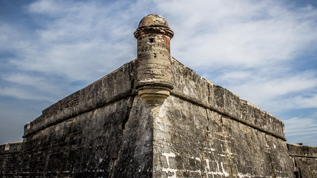 a round guard tower sits at the point of the fort's bastion
