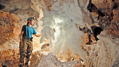 caver near large gypsum cave feature