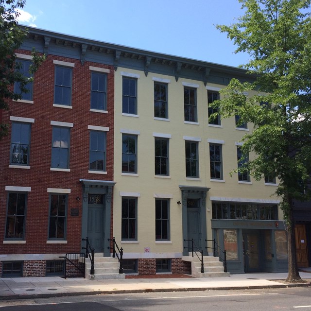 A color photo of the restored site and two adjacent properties